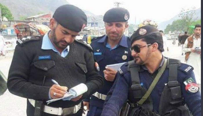 Traffic wardens fine police personnel for not wearing helmet in Chitral
