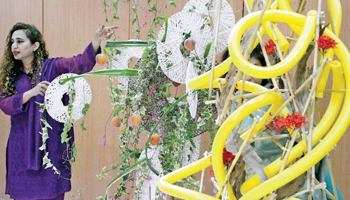 Lahore-based Shaista Khawer, who is certified from Japan in the art of flower arrangement, gives a demonstration during a workshop at the Japanese consulate’s cultural centre on Tuesday. — The News photo by Zahid Rahman