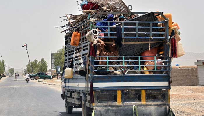 An internally displaced family flees towards the city in Panjwai district of Kandahar province on July 4, 2021, after the Taliban captured a key district in their former bastion of Kandahar after fierce night-time fighting with Afghan government forces, officials said on July 4, sending scores of families fleeing from the area. -AFP