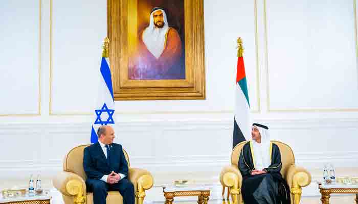 Minister of Foreign Affairs and International Cooperation H.H. Sheikh Abdullah bin Zayed Al Nahyan (R) chats with Israeli Prime Minister Naftali Bennett after his arrival at the Presidential Terminal at Abu Dhabi International Airport on December 12, 2021.-AFP