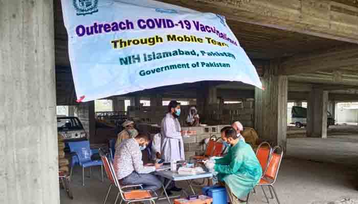 NIH officials administring COVID-19 vaccine at a camp established in Islamabvad. -Photo NIH