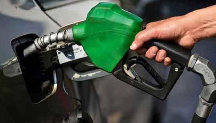 A representational image of a man holding a fuel nozzle at a petrol station. — AFP/File