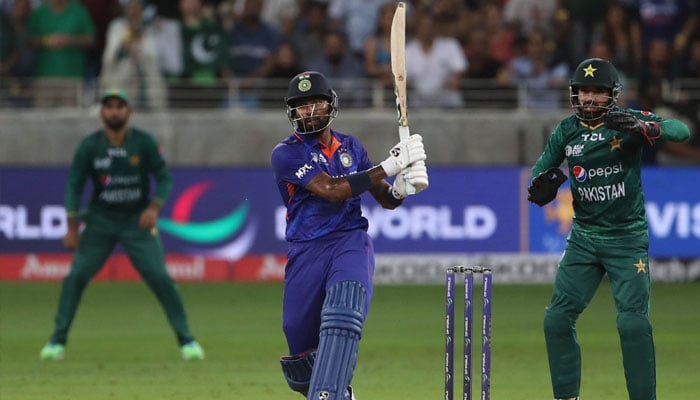 India´s Hardik Pandya hits a boundary to win the Asia Cup Twenty20 international cricket Group A match between India and Pakistan at the Dubai International Cricket Stadium in Dubai on August 28, 2022. —Photo Surjeet Yadav / AFP