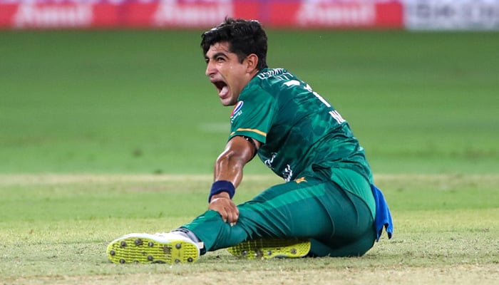 Pacer Naseem Shah holds his leg and screams in pain after delivering the ball during the Asia Cup Twenty20 International Cricket Group A match between India and Pakistan at the Dubai International Cricket Stadium in Dubai, 28 August 2022 raise. — AFP