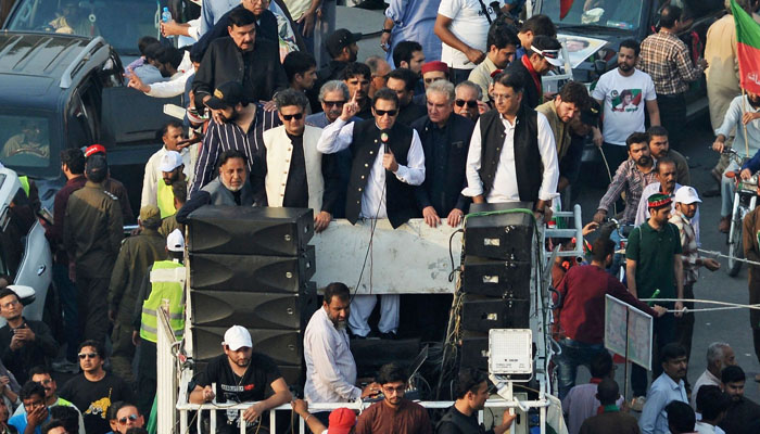 Former Pakistan prime minister Imran Khan addresses his supporters during an anti-government long march towards Islamabad to demand early elections, in Lahore on October 28, 2022. —AFP /Arif Ali