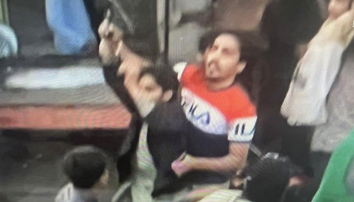 The attacker of Imran Khan being stopped from firing gunshots. Screengrab of a Twitter video.