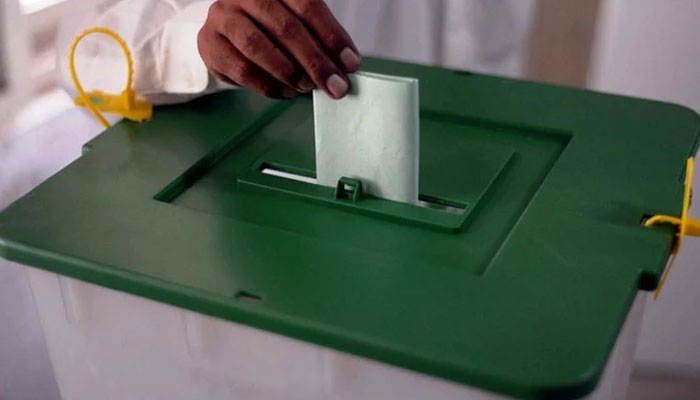 A voter is casting his vote at a polling station during by-elections in the NA-237 constituency in Karachi on October 16, 2022. — PPI