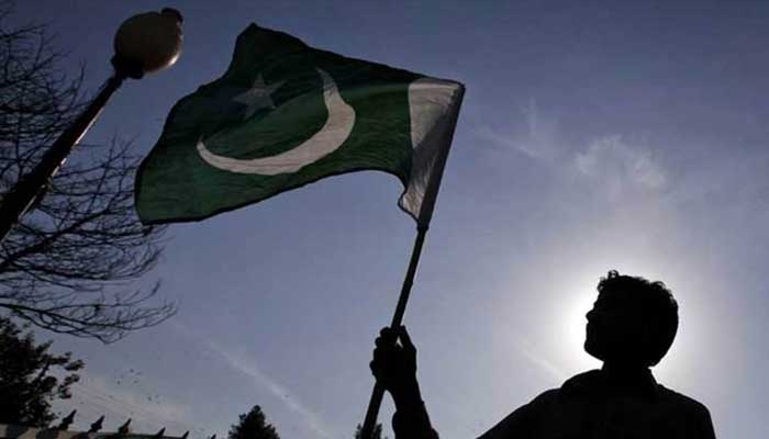 A representational image of a man waving Pakistans flag. — Twitter