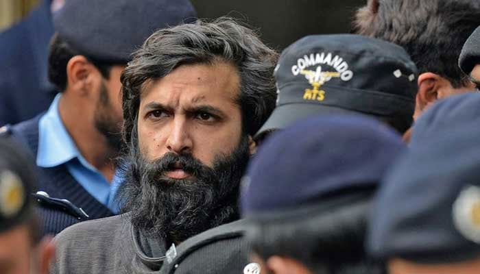 Police escort Zahir Jaffer, the convicted murderer of Noor Mukadam,a 27-year-old woman, to a court. — AFP/File