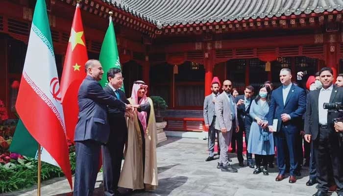 Saudi Arabias Foreign Minister Prince Faisal bin Farhan Al Saud and his Iranian counterpart Hossein Amir-Abdollahian posing for a picture with a Chinese official. — Twitter/@PDChina