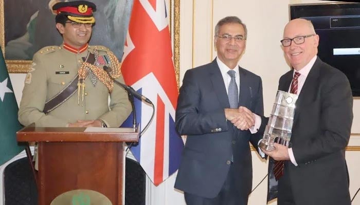 A person receiving an award during a ceremony organised by Quetta Association at Pakistan High Commission London. — Photo by author