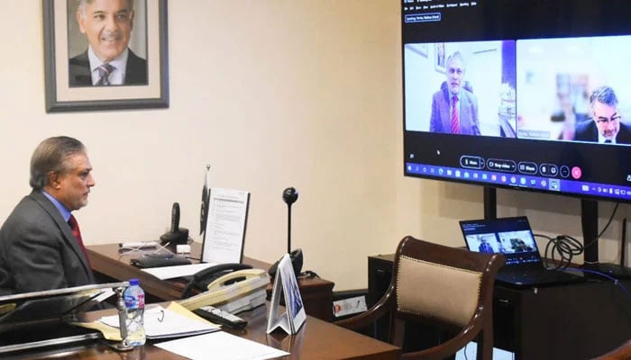 Federal Finance and Revenue Minister Ishaq Dar in a virtual meeting with the International Monetary Fund (IMF) Mission Chief Nathan Porter. —PID