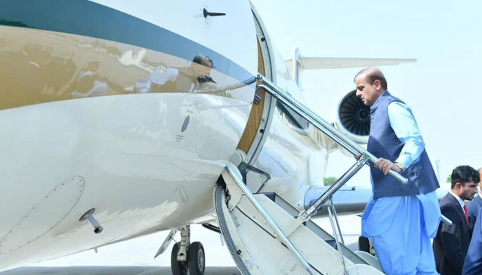 Prime Minister Muhammad Shehbaz Sharif climbs into a plane in this undated photo. — Twitter/@pmln_org