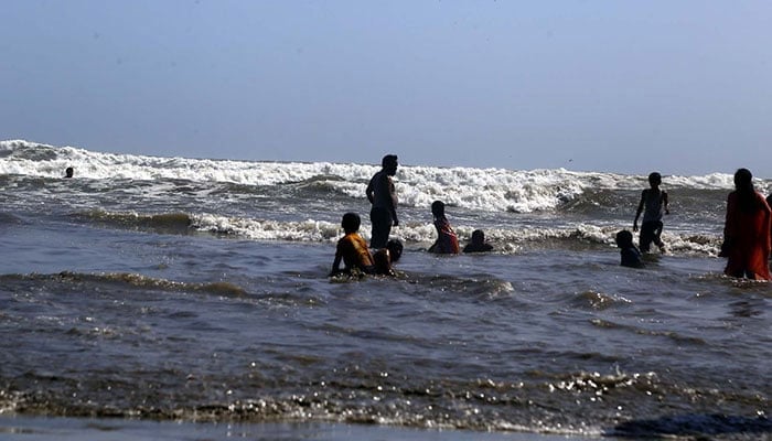 People are seen at Seaview beach despite alerts to remain away ahead of the Extremely Severe Cyclonic Storm Biparjoy, in Karachi on Sunday, June 11, 2023. — PPI