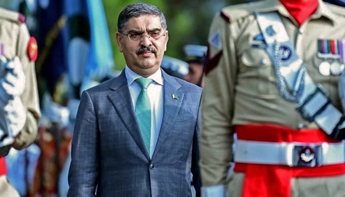 This photograph taken on August 14, 2023, shows caretaker Prime Minister Anwaar-ul-Haq Kakar being presented with a guard of honor at the Presidents House in Islamabad. — AFP