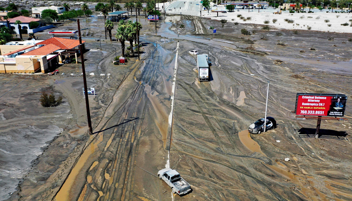 An aerial view of stranded vehicles along a flooded street on August 21, 2023, in Cathedral City, California. — AFP