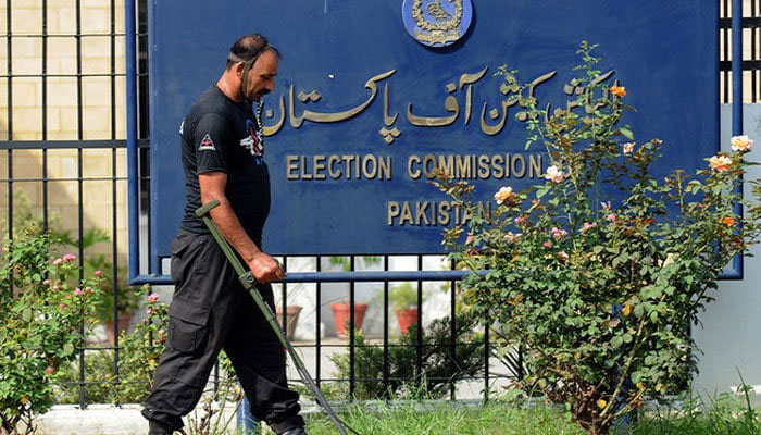 Personnel of the anti-terrorist force uses a metal detector to check the area of the election commission in Islamabad. — AFP/File