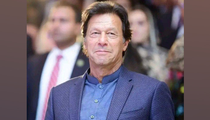 PTI Chairman and former prime minister Imran Khan can be seen smiling during a ceremony. — By the reporter