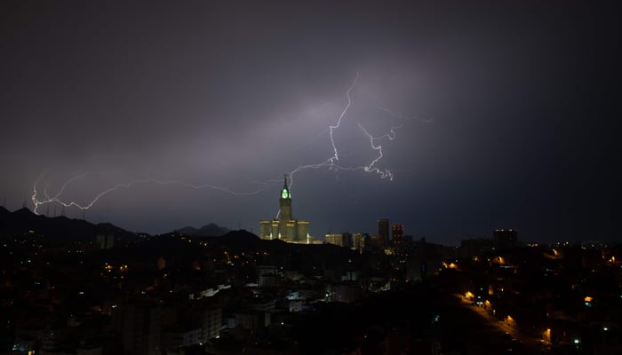 A picture taken on August 22, 2023, shows lightning over Meccas clock tower in Saudi Arabia. — AFP