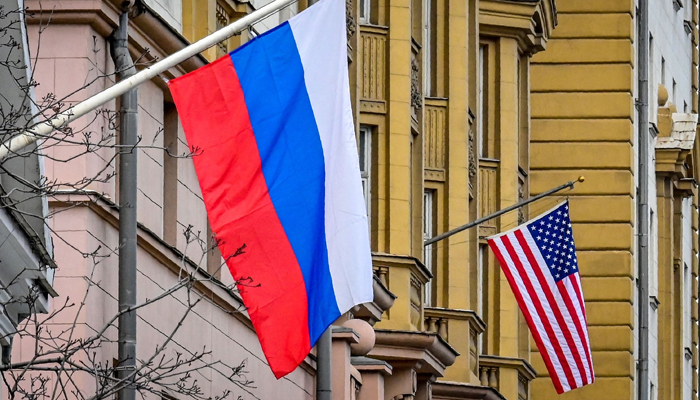 A Russian flag flies next to the US in Moscow. — AFP/File