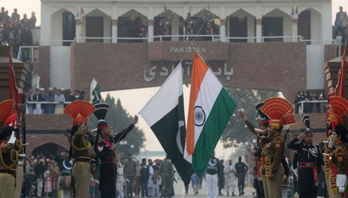 Pakistani (left) and Indian flags can be seen held by the forces of each country in Lahore. — AFP/File