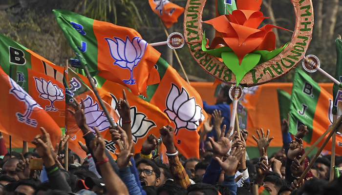 Activists of Bharatiya Janata Party (BJP) wave party flags in Howrah on the outskirts of Kolkata, India, on January 31, 2021. — AFP