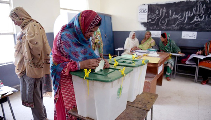 A woman casts her vote during a general election at a polling station in Islamabad. — AFP/File