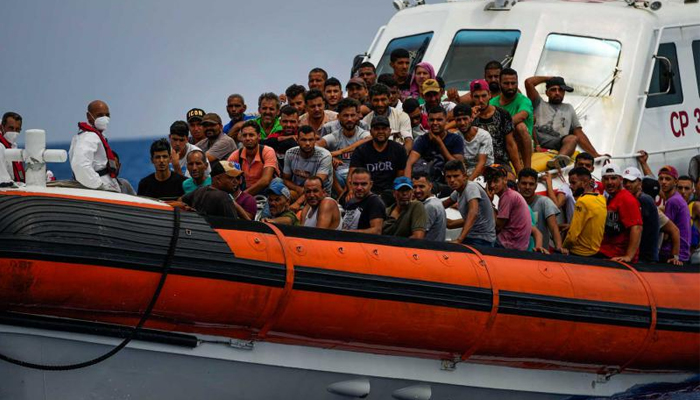 Migrants rest on board an Italian coast guard ship after being rescued southwest of the Italian island of Lampedusa in the Mediterranean sea. — AFP/File