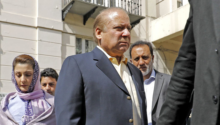 Former prime minister Nawaz Sharif (center) arrives at his office in central London. — AFP/File