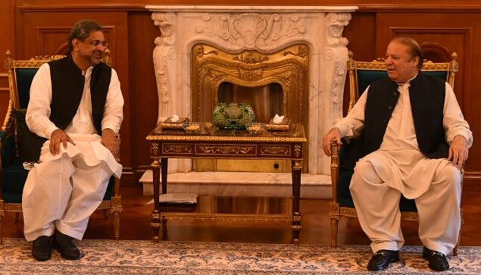 Former prime minister Shahid Khaqan Abbasi (left) while meeting PMLN supremo Nawaz Sharif. — X/PMLN/File