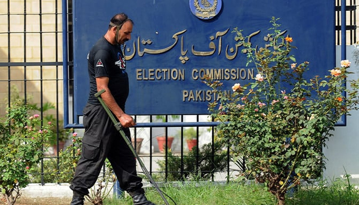 A police personnel can be seen in front of the ECP sign board. — AFP/File
