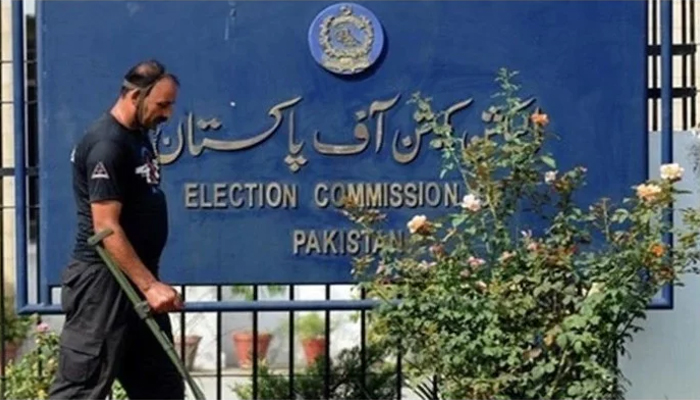 A guard and a signboard outside the Election Commission of Pakistan. — AFP/File