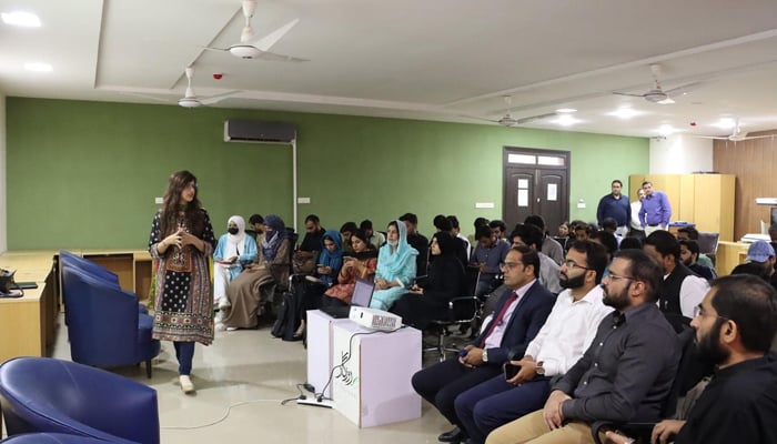 Participants can be seen hearing a speaker in a workshop at NPSC on October 12, 2023. — Facebook/Library E-Library Lahore — Department of Sports & Youth Affairs Punjab