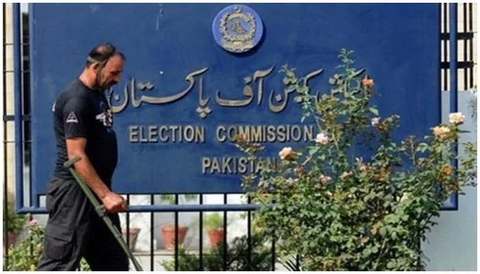 A guard and a signboard outside the Election Commission of Pakistan. — AFP/File