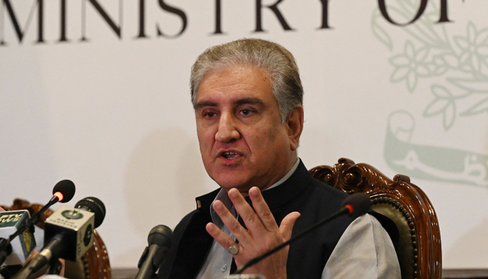 Former Foreign Minister Shah and PTI VC Mahmood Qureshi speaking during a press conference in Islamabad. — AFP/File