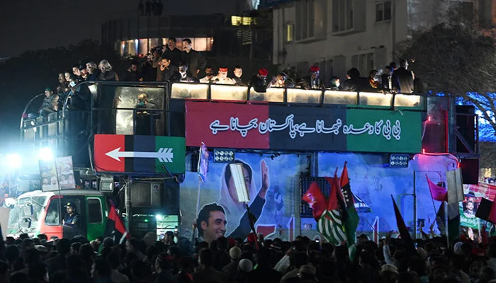 Supporters of PPP gather around a truck carrying Chairman of PPP Bilawal Bhutto Zardari, leading a rally in Islamabad on March 8, 2022. — AFP