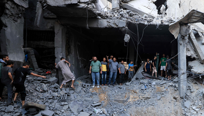 Palestinians look for survivors in the rubble of a building hit during Israeli bombardment in Khan Yunis on the southern Gaza Strip on October 19, 2023. — AFP