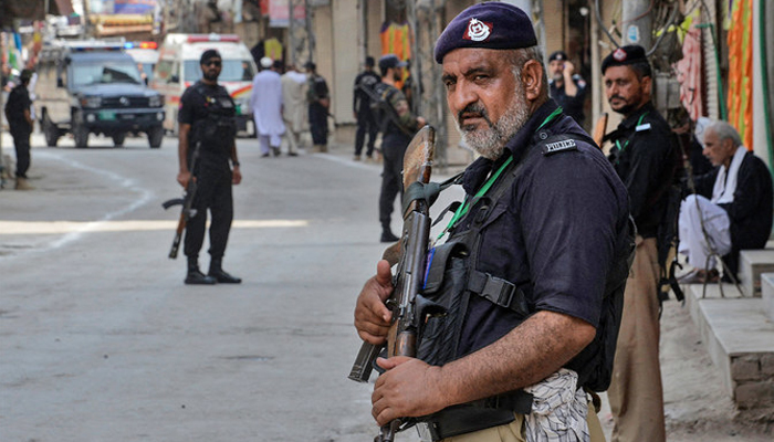 A representational image shows Peshawar police personnel standing guard. — AFP/File