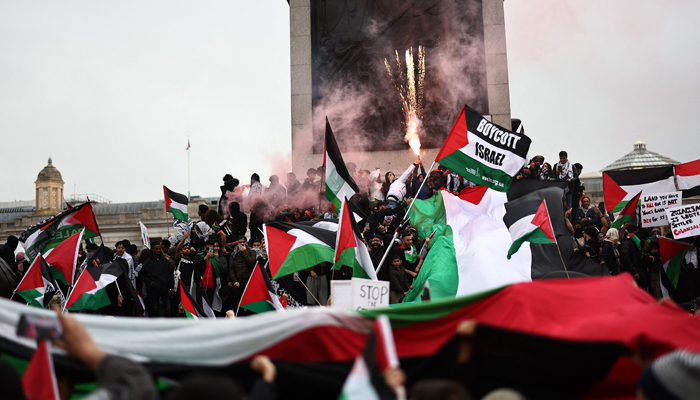 People take part in a March For Palestine, in London on October 21, 2023, to demand an end to the war on Gaza. — AFP