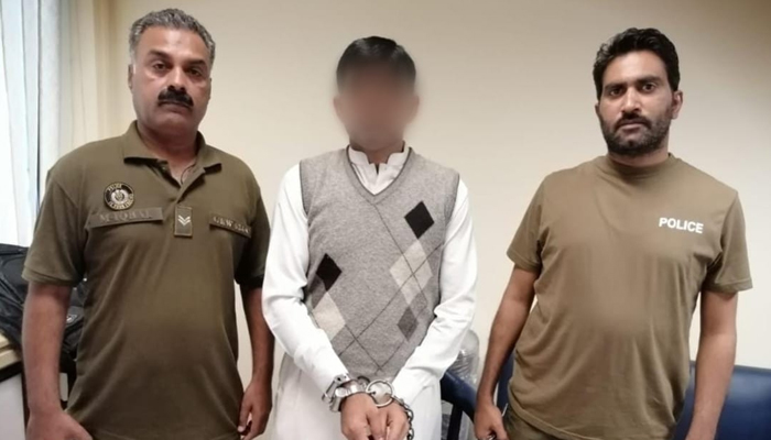 Punjab police officials stand for a picture with a criminal (c) involved in a murder case on October 22, 2023. — X/@OfficialDPRPP