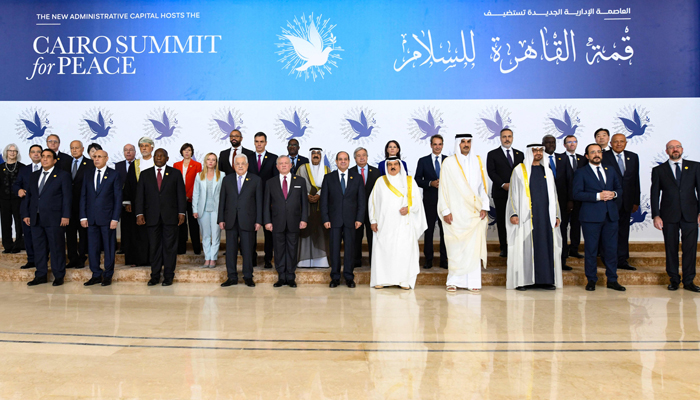 This picture shows Egypts President Abdel-Fattah al-Sisi (C) flanked by regional and some Western leaders, posing for a family picture during the International Peace Summit in Cairo on October 21, 2023. — AFP