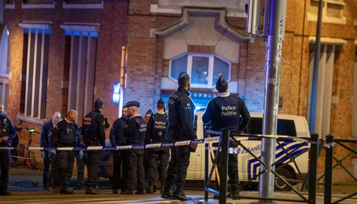 Police set a perimeter at the site of a shooting incident in the Ieperlaan — Boulevard d’Ypres, in Brussels, on October 16, 2023. – AFP