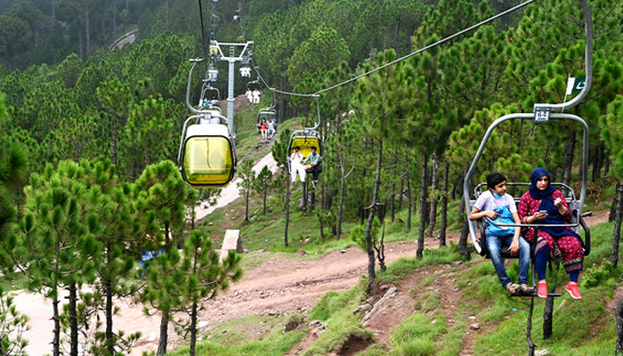 Tourists sit on chairlifts at the Patriata Resort near Murree, some 65 km from Islamabad, Pakistan, on August 16, 2020. — AFP