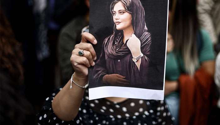 A protester holds a portrait of Mahsa Amini during a demonstration in her support in front of the Iranian embassy in Brussels on September 23, 2022, following the death of an Iranian woman after her arrest by the country´s morality police in Tehran. AFP/File