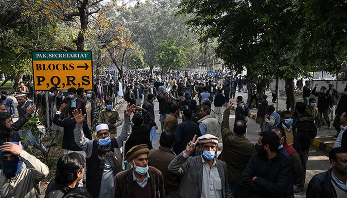 Federal government employees gather while they march toward the Parliament House during a protest to demand higher wages. — AFP/File