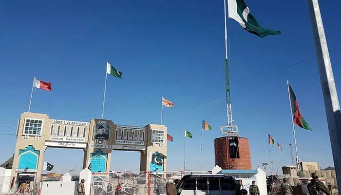 This photograph shows Pakistan security personnel looking on as travellers wait to cross the border between Pakistan and Afghanistan at Chaman. — AFP/File