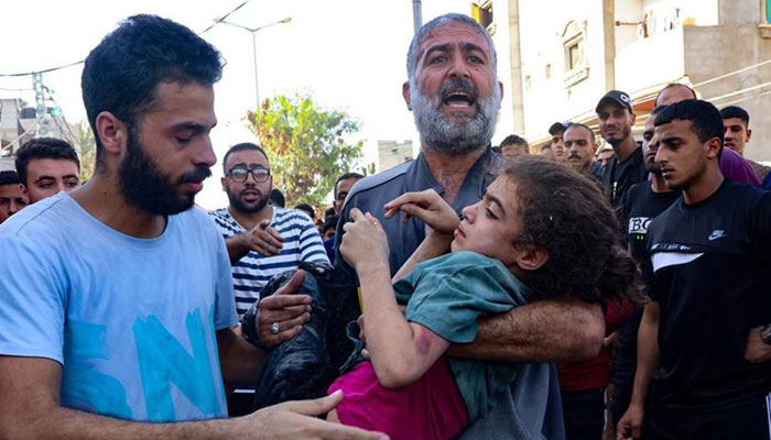 n injured girl is transported to a hospital in the aftermath of Israeli strikes on the Rafah refugee camp in the southern Gaza Strip on October 25, 2023. — AFP