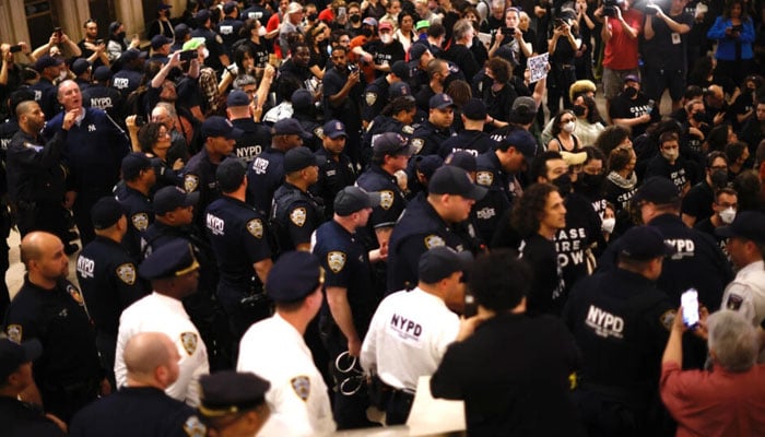 NYPD officers move in on a sit-in organised by Jewish groups calling for a ceasefire in the Israel-Hamas war, at Grand Central station in New York City. — AFP