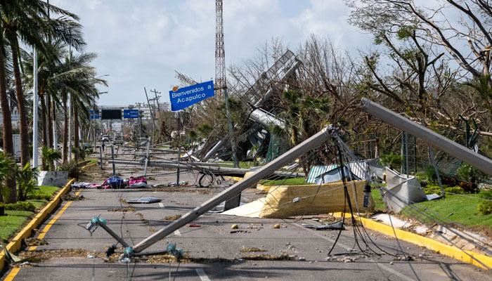 Downed electrical poles and lines blown over by Hurricane Otis blanket a road in Acapulco, Mexico, Friday, Oct. 27, 2023. — CNN