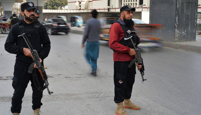 Police officials can be seen standing guard. — AFP/File